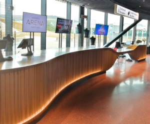 Curved reception counter with brass top and illuminated base