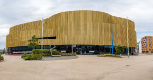Exterior view of Swansea Arena featuring a gold perforated aluminium facade