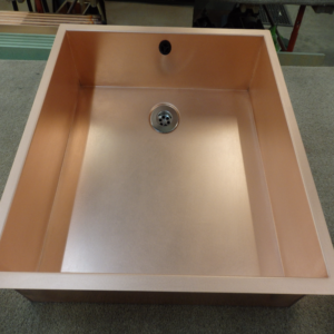 Drop-in copper sink set into a worktop with satin finish