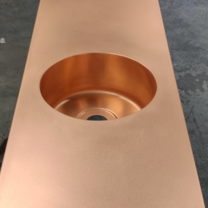 Round copper bowl sink fitted into slim copper worktop