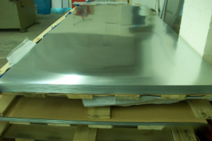 Bright mill finish zinc sheets stacked on pallet in warehouse before patination