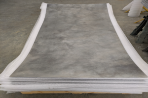 Stack of patina zinc sheet metal on a pallet with protective foam ready for delivery