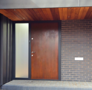Rusted Corten steel front door with bespoke cladding and modern frame