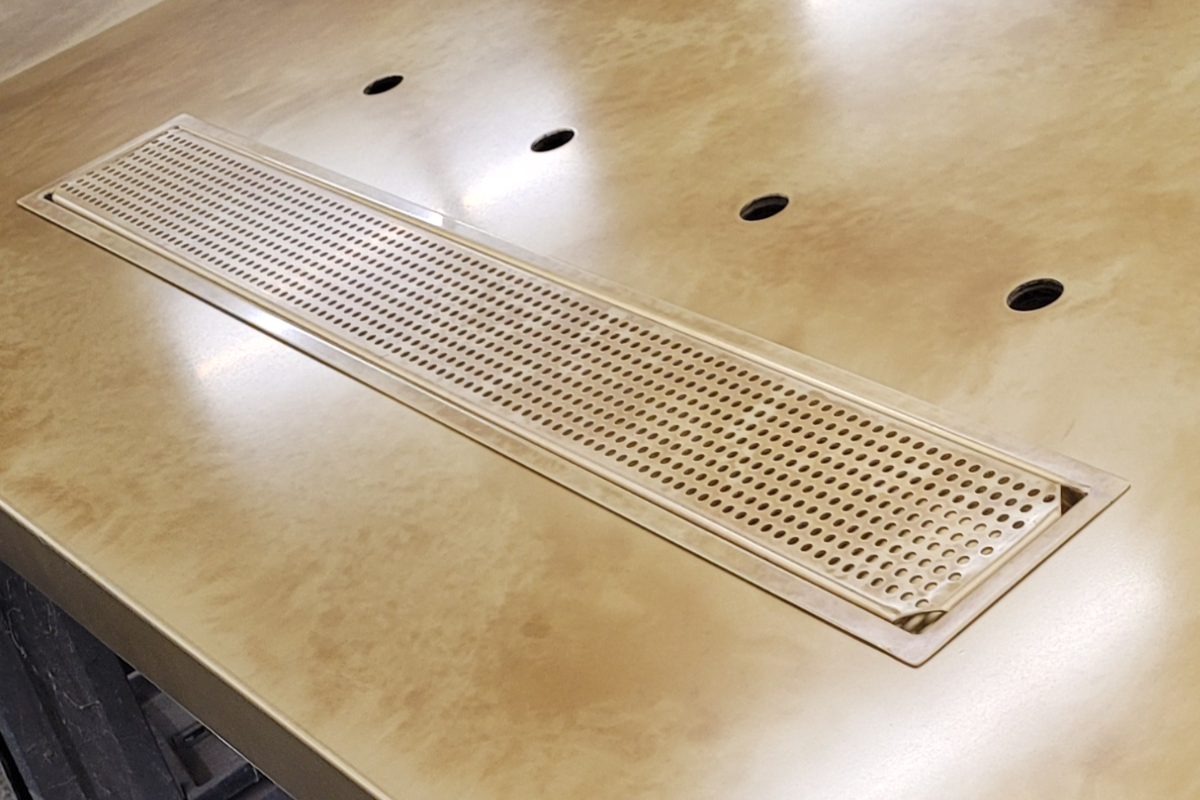 Brass panel with round perforations and folded edge