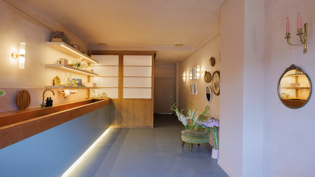 Bespoke copper trough sink forming a feature counter in a floral studio interior