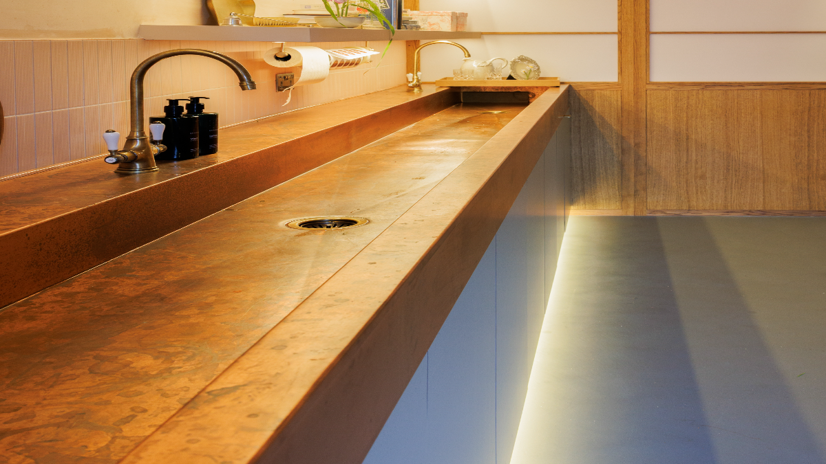 Six-metre bespoke copper trough sink installed in a London floral studio